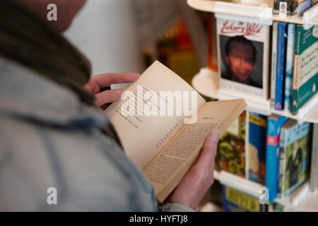 Person reading a book in a book shop, Book Festival, Laugharne Stock Photo
