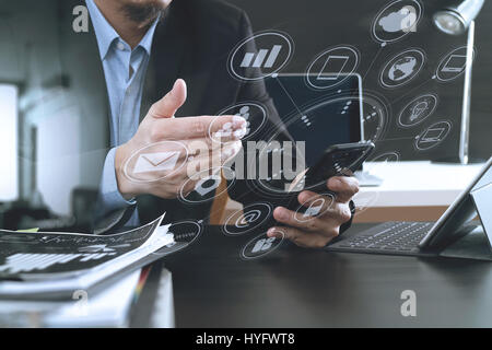 businessman working with smart phone and digital tablet and laptop computer in modern office with virtual interface graphic icons network diagram Stock Photo
