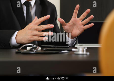 smart medical doctor working with smart phone and digital tablet computer and stethoscope on wood desk in modern office Stock Photo
