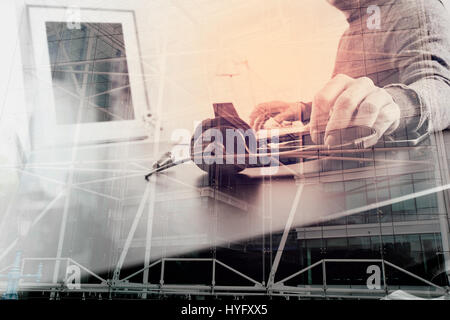 Man using VOIP headset with latop computer on desk in modern office as call center and customer service help desk concept with London city background, Stock Photo