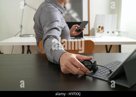 businessman using VOIP headset with digital tablet computer and smart phone,as concept communication and call center or customer service help desk in  Stock Photo