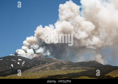 SICILY, ITALY: MOUNT Etna has been photographed exploding into life during its most recent eruption yesterday. Pictures show smoke billowing out from the top of the active volcano during the day. Other Images show Etna at night with glowing red molten lava trailing down the mountainside. The images were captured by local photographer Marco Restivo. Stock Photo