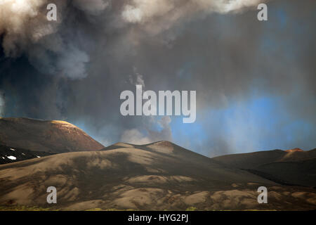 SICILY, ITALY: MOUNT Etna has been photographed exploding into life during its most recent eruption yesterday. Pictures show smoke billowing out from the top of the active volcano during the day. Other Images show Etna at night with glowing red molten lava trailing down the mountainside. The images were captured by local photographer Marco Restivo. Stock Photo