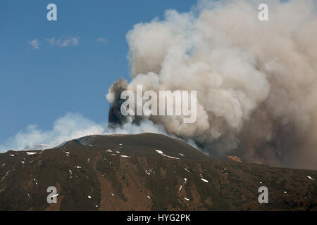 SICILY, ITALY: MOUNT Etna has been photographed exploding into life during its most recent eruption yesterday. Pictures show smoke billowing out from the top of the active volcano during the day. Other Images show Etna at night with glowing red molten lava trailing down the mountainside. The images were captured by local photographer Marco Restivo. Stock Photo