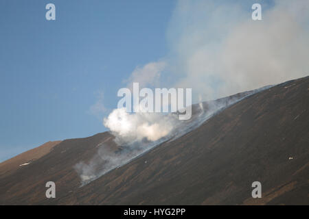 SICILY, ITALY: MOUNT Etna has been photographed exploding into life during its most recent eruption yesterday. Pictures show smoke billowing out from the top of the active volcano during the day. Other Images show Etna at night with glowing red molten lava trailing down the mountainside. The images were captured by local photographer Marco Restivo. Stock Photo