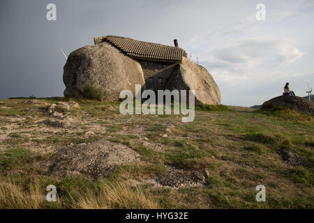 FAFE MOUNTAINS, PORTUGAL: COULD this real-life Flintstones house be the most impregnable yet bizarre on the planet? Nestled between four mighty granite boulders, two-thousand six hundred feet high in the Fafe Mountains in Portugal, this extraordinary dwelling with bullet-proof doors and windows is known as ‘Casa do Penedo’ or ‘House of Stone’. Portuguese photographer Ricardo Oliveira Mateus (34) was able to reach this house of rock and snap the unusual character of this sixteen and a half feet tall former holiday home. Stock Photo