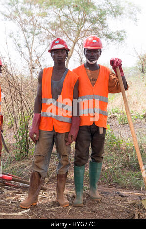 Villagers in a road construction crew in the Central African Republic take a break from a project, funded by the World Bank, to repair a dirt road. Stock Photo