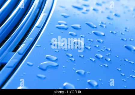 raindrops on a blue metal vehicle panel Stock Photo