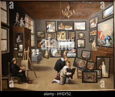 An Artist in his Gallery, a painting by Thomas van Opshoven after David Teniers the Younger, circa 1650, presenting an artist in his workshop with two gentlemen studying a small painting. Stock Photo