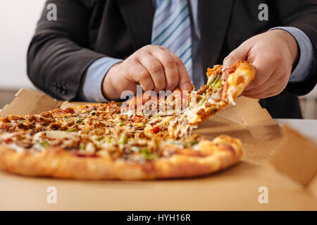 Frontline company employee eating pizza Stock Photo