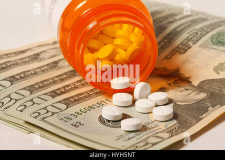 Drug Money - Prescription drugs on twenty dollar bills. Stock Photo