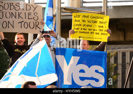 Anti-Conservative protesters and 'Yes' supporters demonstrate outside the Hillton Hotel in Glasgow, where Prime minister David Cameron was addressing a CBI Scotland dinner three weeks before the Scottish independence referendum Stock Photo
