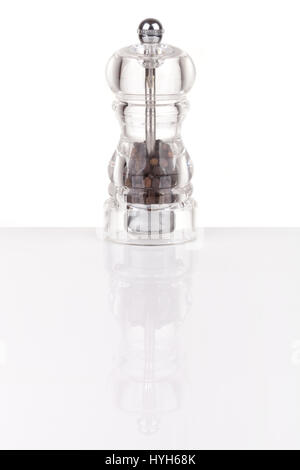 Pepper grinder made of glass isolated on white, with reflection Stock Photo
