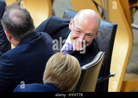 Finance Secretary John Swinney shares a light aside with Nicola Sturgeon after Alex Salmond (L) delivered his formal resignation statement as First Minister of Scotland Stock Photo