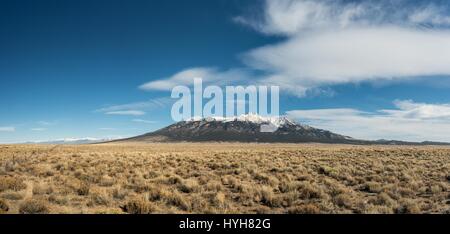 Snow capped mountain range taken from inside moving car Stock Photo