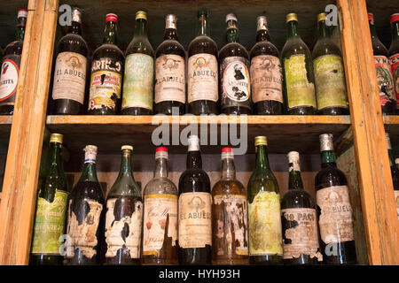 Old vintage bottles inside a bar in San Telmo. Buenos Aires, Argentina. Stock Photo