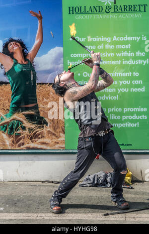 Street artist performing fire eating on a Whitby Street. Stock Photo