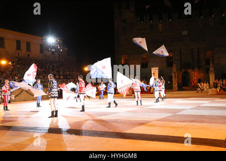 Marostica, VI, Italy - September 9, 2016: flag wavers during night fantastic show with Evolutions of big flags