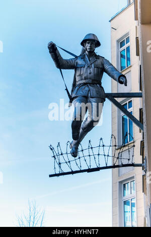Berlin,Mitte.Wall jumper,Jumping soldier sculpture.East German Border guard, Conrad Schumann, jumps over barbed wire to escape from East Berlin Stock Photo