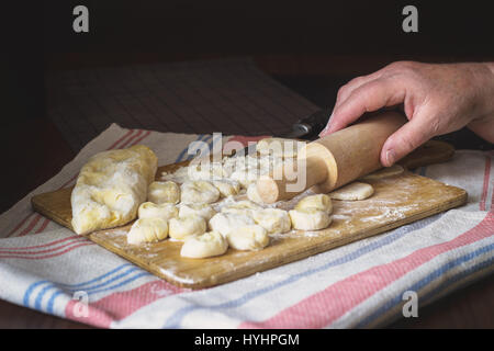 Old woman's hands cooking Ukrainian traditional dumplings with cottage cheese Stock Photo