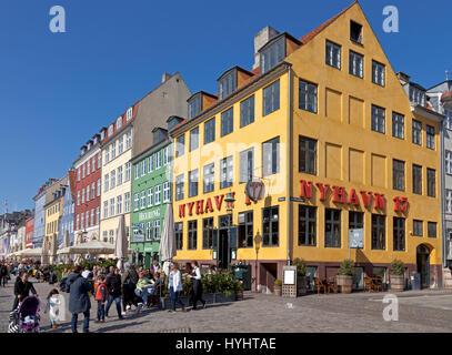 The waterfront restaurants in Nyhavn, Copenhagen, Denmark, attract many Copenhageners and tourists on a sunny spring day in early April Stock Photo