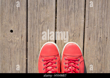 Pink sneakers on the wooden boards Stock Photo