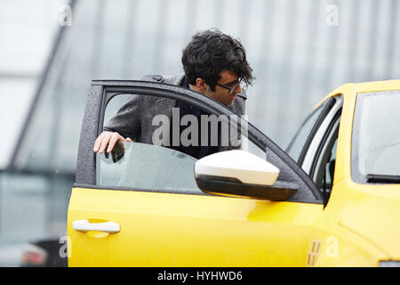 Young Businessman Getting In Taxi Stock Photo