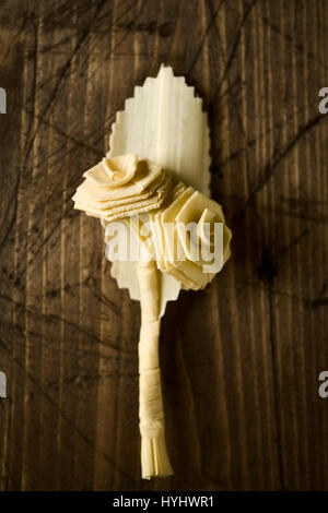 closeup of a small traditional spanish braided palm to be blessed on Palm Sunday on a rustic wooden surface Stock Photo