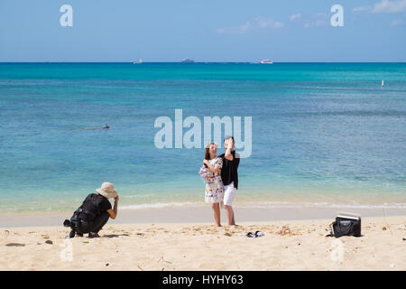 HONOLULU, OAHU, HAWAII - FEBRUARY 22, 2017: Engaged couple photographed on Waikiki Beach with the city of Honolulu in the background of their engageme Stock Photo