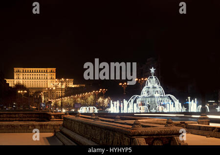 Fountain lighted and ornaments in front of The House of People, downtown of  Bucharest, Romania night time. Stock Photo