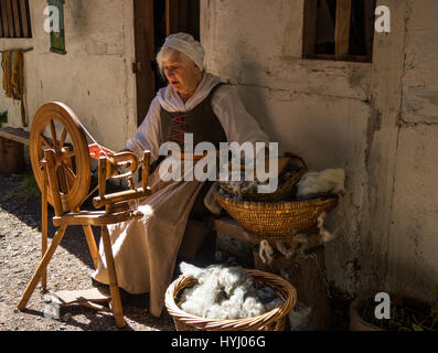 Lady spinning wool at the Living History Village of Little Woodham in the The Seventeenth Century near Gosport, Hampshire Stock Photo