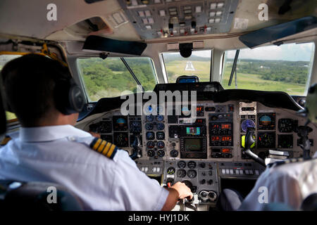 Landing, pilot and copilot control the twin-engine propeller aircraft British Aerospace Jetstream 3200, La Isabela International Stock Photo