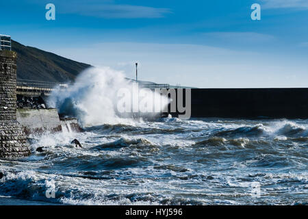 Aberystwyth Wales UK, Tuesday 04 April 2017 UK Weather: Blustry cold northerly winds whip up the waves crashing into the promenade under blue skies in Aberystwyth on the west Wales coast Credit: keith morris/Alamy Live News Stock Photo