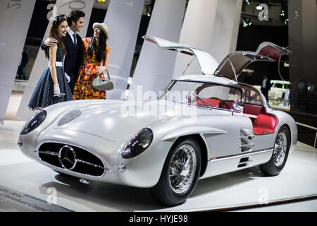 Essen, Germany. 5th Apr, 2017. The models Marcel (L-R), Vivien and Maret stand adjacent to Mercedes Benz 300 SLR 'Uhlenhaut-Coupe' (W 196 S) from 1955 at the Techno Classica for 'Oldtimers' and 'Youngtimers' in Essen, Germany, 5 April 2017. The world trade fair will take place from the 5th to the 9th April. Photo: Marcel Kusch/dpa/Alamy Live News Stock Photo