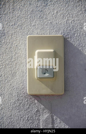 door bell on white gatepost front of house Stock Photo