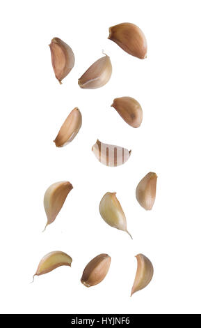 Falling garlic cloves isolated on white background. Stock Photo