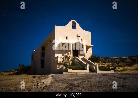 Gozo, Malta - The Saint Anne or Sant' Anna Chapel at Dwejra bay by night on the island of Gozo at full moon Stock Photo