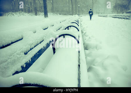 Lots of snow on benches and paths in Central Park. Stock Photo