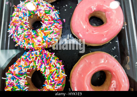 Orlando Winter Park Florida,Krispy Kreme Doughnuts,donut company,coffeehouse,sprinkles,pink glaze,donuts,icing,display sale product,visitors travel tr Stock Photo