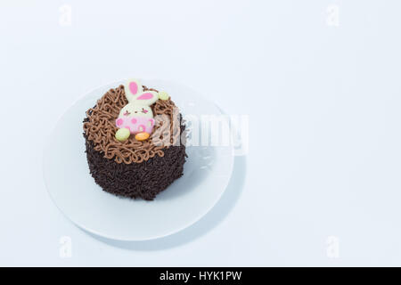 Small chocolate cake - brigadeiro - with Easter bunny detail on a white dish isolated in white background Stock Photo