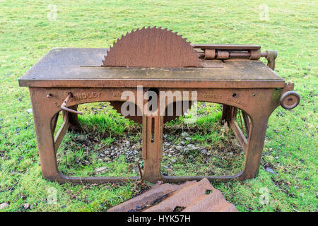 Old belt driven saw bench, made by E. S. Hindley of Bourton, Dorset but lying in a field on the west coast of Scotland Stock Photo