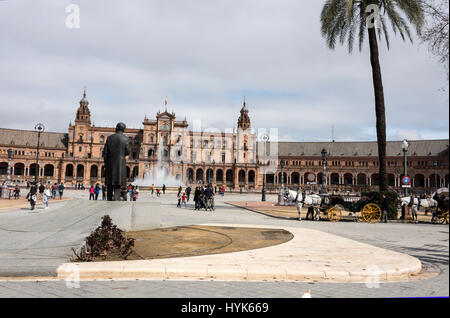 Tourists flock to the semi-circle frontage of the  Plaza de Espana, a popular venue in Seville, Spain.   The site is the biggest construction of the I Stock Photo