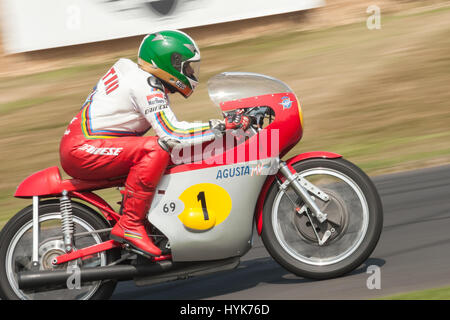 Goodwood, UK - July 13, 2013: Fifteen times motorcycle world champion Giacomo Agostini riding his classic MV Agusta motorcycle at the Festival of Spee Stock Photo