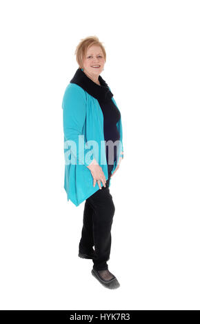 A senior citizen woman with blond hair wearing a blue jacket standing smiling in profile, isolated for white background. Stock Photo