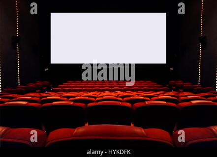 Empty cinema seats with blank white screen Stock Photo