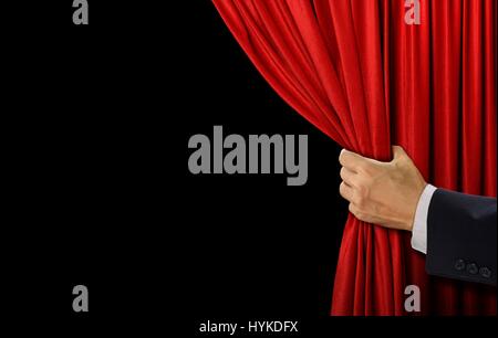 Hand open stage red curtain on black background Stock Photo
