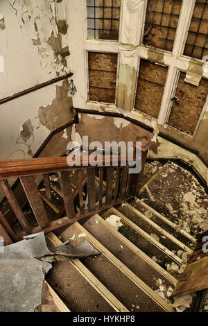 MALVERN, ENGLAND: A picture of the staircase inside the abandoned care home with boarded up windows and peeling paint on the walls. LOOK INSIDE the home where heroic nurse Florence Nightingale believed her life was saved upon returning to Britain from her service during the Crimean War. Pictures show the one time centre for ‘water cure’ treatment in Malvern, Malvernbury, which became a frequent stop for Florence Nightingale between 1857 and 1860 while she recovered from the effects of war which left her suffering severe anxiety and exertion. Another famous convert to Malvern’s water cure inclu Stock Photo