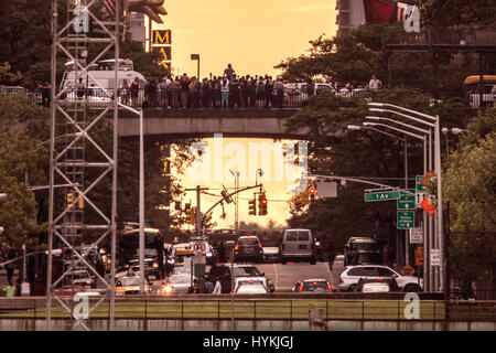 New York City, USA: IN A HOMAGE of Britain’s legendary Stonehenge gatherings New Yorkers flocked to witness the Sun as it set on the final “Manhattanhenge” of 2016. Pictures show how sun worshippers stood awe-struck as the blazing sun slowly descended between the towers of 42nd Street – known to local New Yorkers as the very heart of their city. This solar event occurs just twice a year when the sun cuts east to west exactly across the streets of Manhattan. The last was seen on May 28th this year. NYC photographer Peter Alessandria described the scene. Stock Photo