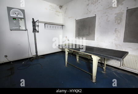 Medical examination room. SHOCKING photos show the abandoned remains of Britain’s most notorious prisons where convicted IRA and Ulster Loyalist terrorists were held. From dilapidated cells and barbed wire fencing to medical facilities and the family visiting room the images showcase what is left of HM Prison Maze in Northern Ireland which closed in 2000. The prison housed paramilitary prisoners during the Troubles that blighted Great Britain and Ireland until the Good Friday Agreement in 1998 and is perhaps most well-known as the place where ten Irish Republican prisoners starved themselves t Stock Photo
