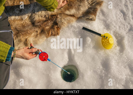 Ice Fishing by Kangos Guesthouse, Lapland Sweden Stock Photo